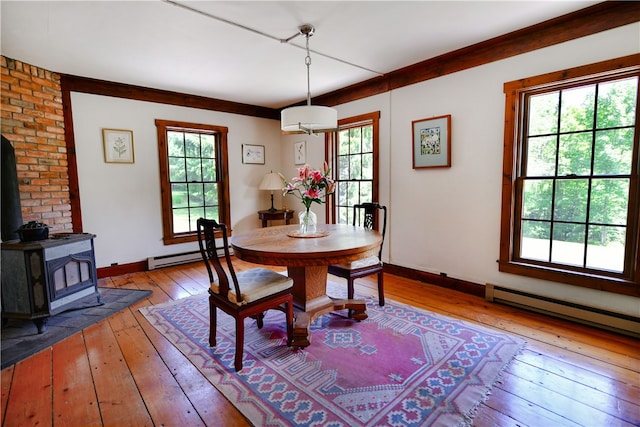 2943 Thompson Hollow Rd, Middletown, NY 12455 - dining room featuring hardwood / wood-style floors, a baseboard radiator, and a wood stove