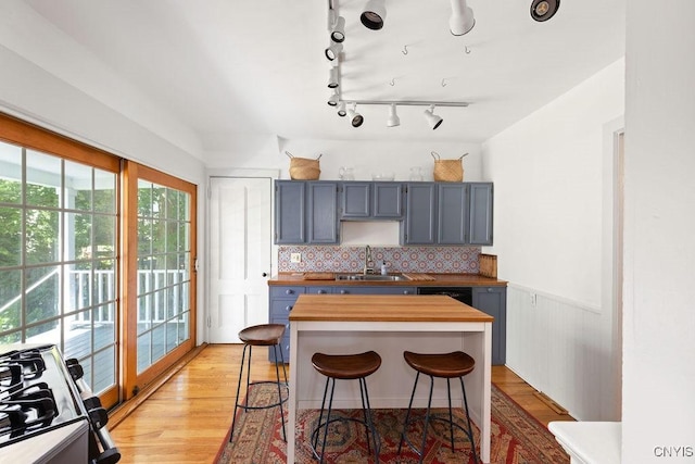 6 Union St, Cazenovia, NY 13035 - kitchen featuring range, butcher block counters, a breakfast bar area, tasteful backsplash, and gray cabinets