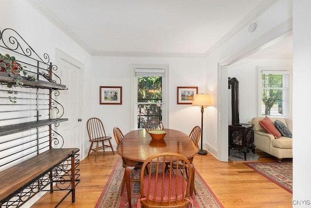 6 Union St, Cazenovia, NY 13035 - dining space with a wood stove, healthy amount of natural light, light wood finished floors, and crown molding