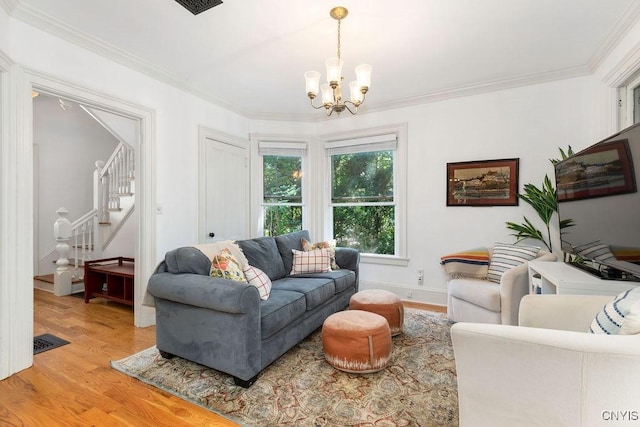 6 Union St, Cazenovia, NY 13035 - living area with light wood-type flooring, a chandelier, stairway, and crown molding