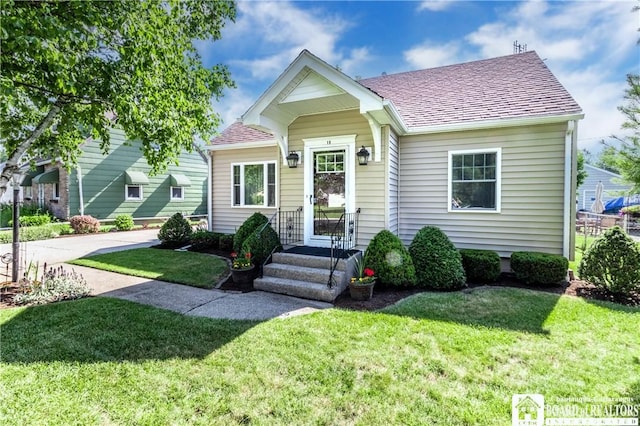 19 Darwin Dr, Lancaster, NY 14043 - view of front of home with a front lawn and roof with shingles