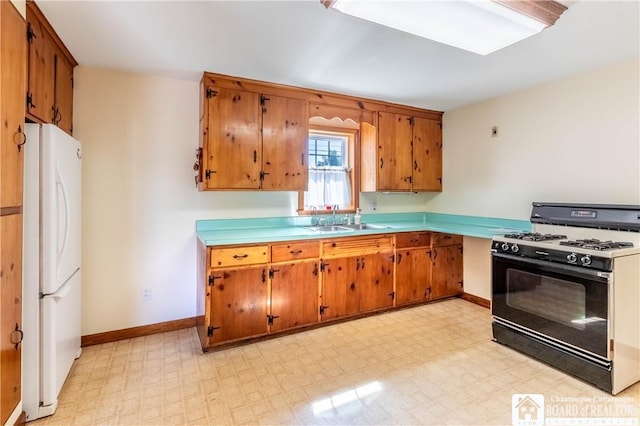 19 Darwin Dr, Lancaster, NY 14043 - kitchen featuring black gas range oven, freestanding refrigerator, and brown cabinets