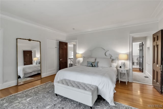 6862 Lake Shore Rd, Evans, NY 14047 - bedroom featuring ornamental molding, wood finished floors, and connected bathroom