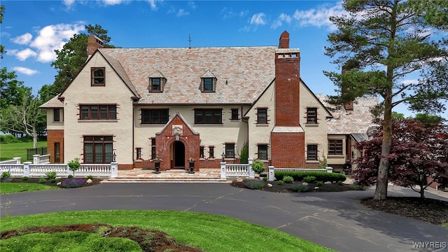 6862 Lake Shore Rd, Evans, NY 14047 - english style home featuring a high end roof, a chimney, and brick siding