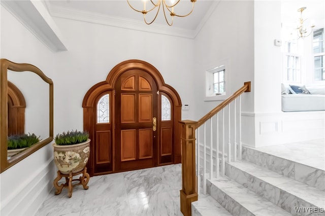 6862 Lake Shore Rd, Evans, NY 14047 - foyer entrance with a chandelier, ornamental molding, healthy amount of natural light, light marble finish floors, and a high ceiling