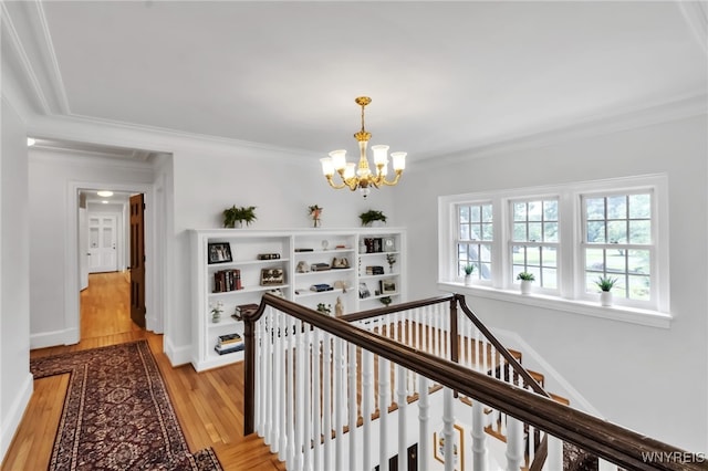 6862 Lake Shore Rd, Evans, NY 14047 - corridor featuring a chandelier, an upstairs landing, light wood-style flooring, and ornamental molding