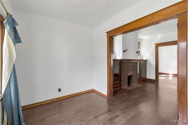 20 Rejtan St, Buffalo, NY 14206 - unfurnished living room featuring a brick fireplace and wood finished floors