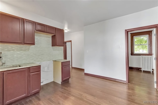 20 Rejtan St, Buffalo, NY 14206 - kitchen featuring radiator, decorative backsplash, and dark wood-style floors