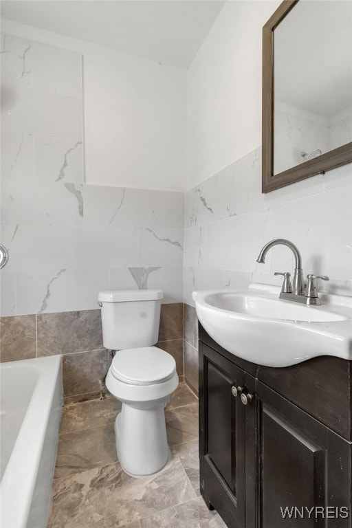 20 Rejtan St, Buffalo, NY 14206 - bathroom with tile walls, vanity, a tub, and marble finish flooring