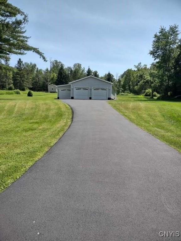 7408 Rome Oriskany Rd, Rome, NY 13440 - view of front facade featuring a garage, a front lawn, and an outbuilding