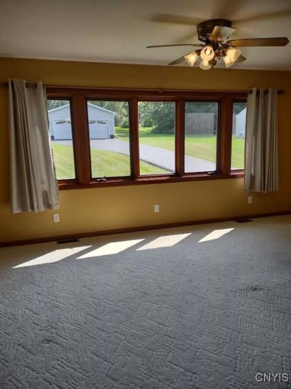 7408 Rome Oriskany Rd, Rome, NY 13440 - empty room with carpet floors and a ceiling fan