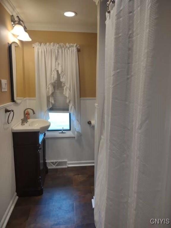 7408 Rome Oriskany Rd, Rome, NY 13440 - bathroom featuring vanity, wainscoting, ornamental molding, and recessed lighting