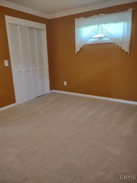 7408 Rome Oriskany Rd, Rome, NY 13440 - unfurnished bedroom featuring ornamental molding, light carpet, and a closet