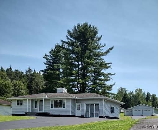 7408 Rome Oriskany Rd, Rome, NY 13440 - single story home with a garage, a front yard, and an outdoor structure