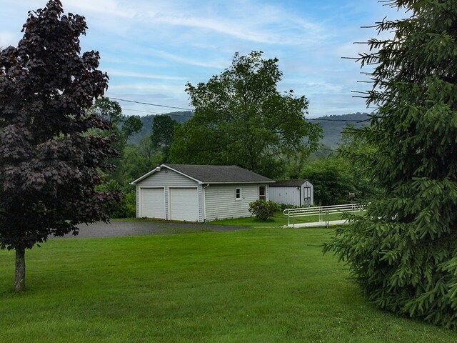 8198 Rte 46, Keating Town, PA 16749 - view of green lawn with a garage and a storage shed