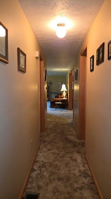 8198 Rte 46, Keating Town, PA 16749 - corridor featuring dark carpet and a textured ceiling