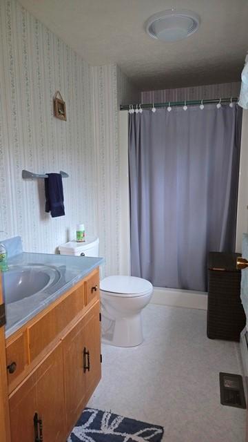 8198 Rte 46, Keating Town, PA 16749 - full bath featuring vanity, curtained shower, and wallpapered walls