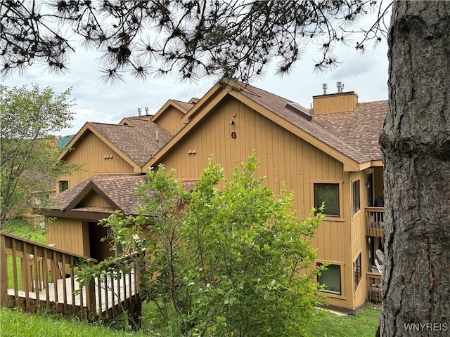 G103 Snowpine Vlg, Great Valley, NY 14741 - view of side of home with roof with shingles and a chimney