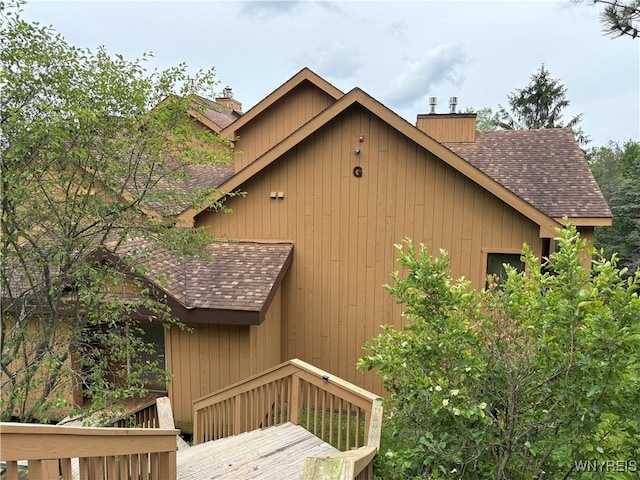 G103 Snowpine Vlg, Great Valley, NY 14741 - view of property exterior with a chimney, roof with shingles, and a deck