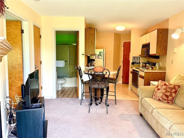 G103 Snowpine Vlg, Great Valley, NY 14741 - kitchen with white range with electric cooktop, fridge, light carpet, black microwave, and light countertops