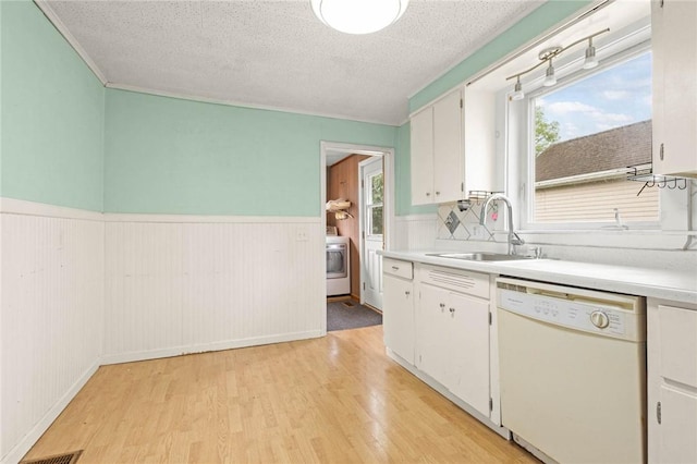 113 Myrtle St, Leroy, NY 14482 - kitchen with dishwasher, washer / clothes dryer, light wood-style flooring, a wainscoted wall, and light countertops