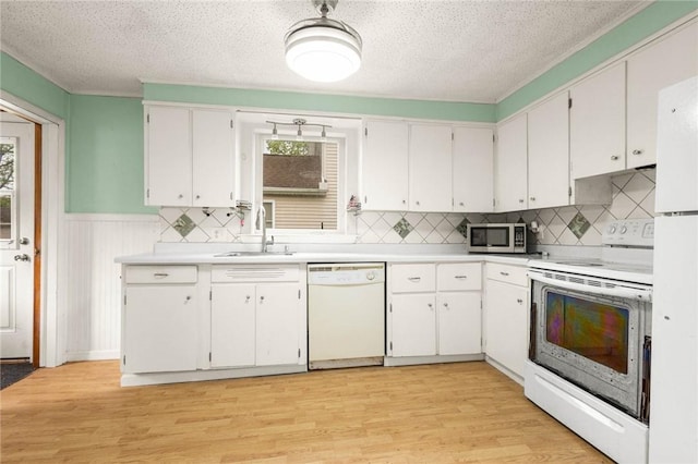 113 Myrtle St, Leroy, NY 14482 - kitchen featuring white appliances, light wood-type flooring, light countertops, white cabinets, and a wainscoted wall