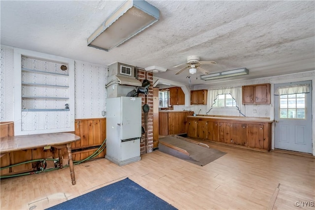 7259 Number Four Rd, Watson, NY 13367 - misc room featuring light wood-style floors, a textured ceiling, a ceiling fan, and wallpapered walls