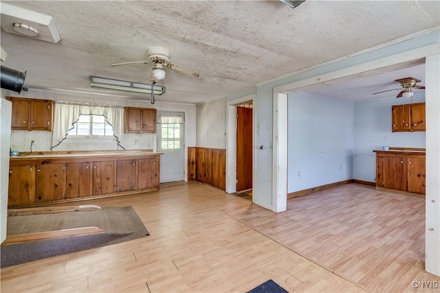 7259 Number Four Rd, Watson, NY 13367 - kitchen with a ceiling fan, light wood-type flooring, brown cabinetry, a textured ceiling, and light countertops
