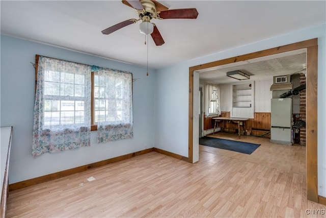 7259 Number Four Rd, Watson, NY 13367 - unfurnished room featuring wood finished floors, baseboard heating, and a ceiling fan