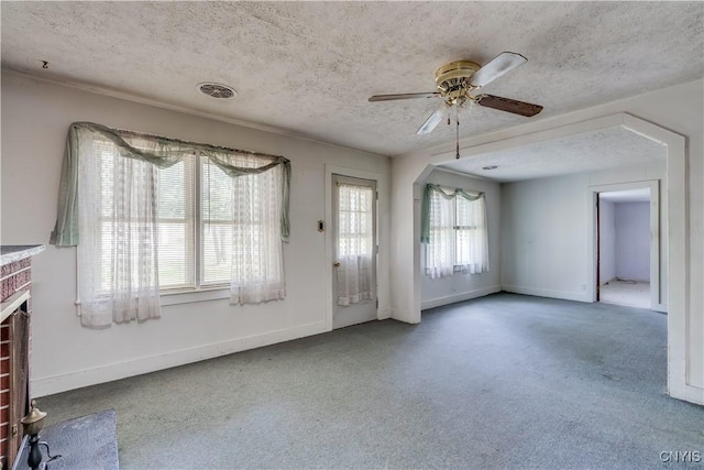 7259 Number Four Rd, Watson, NY 13367 - unfurnished living room with a ceiling fan, a brick fireplace, a textured ceiling, and carpet flooring