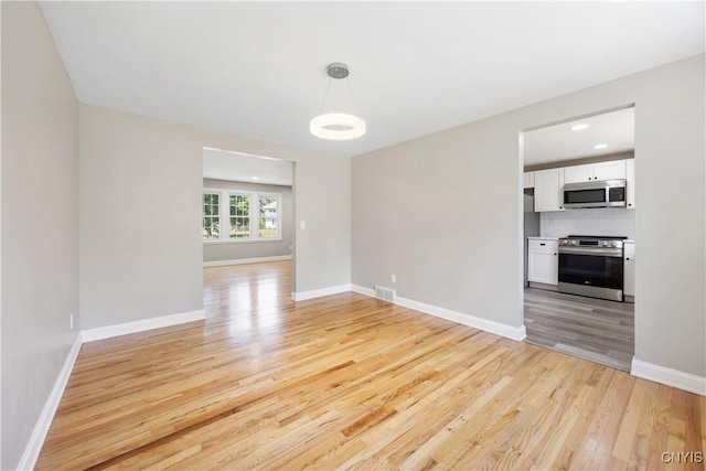 14 Ibis, Clay, NY 13090 - spare room featuring light wood finished floors and baseboards