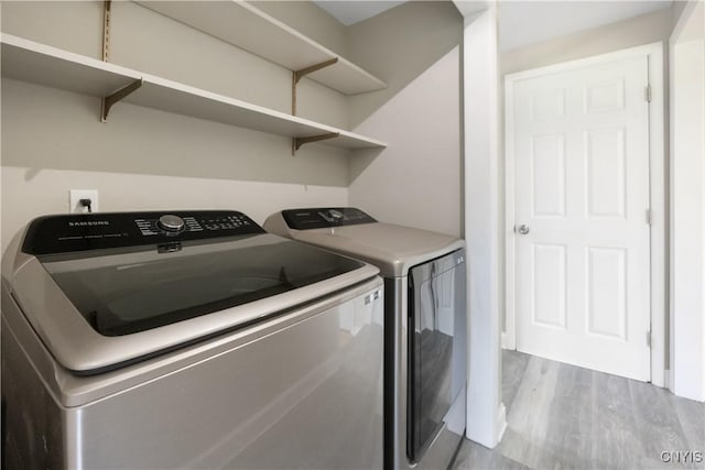 14 Ibis, Clay, NY 13090 - laundry area with washing machine and clothes dryer and wood finished floors