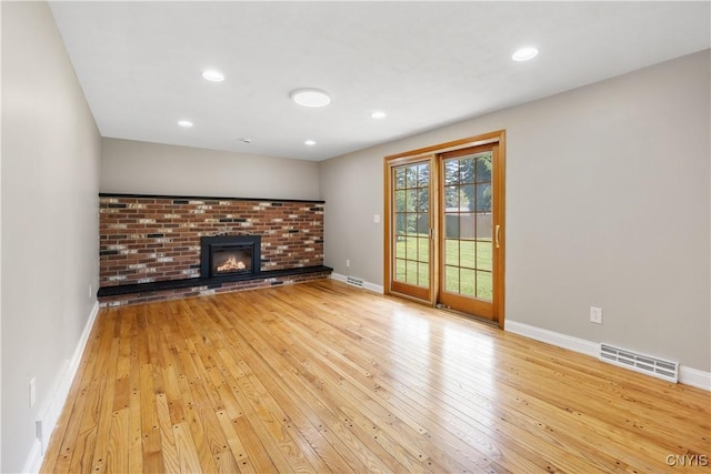 14 Ibis, Clay, NY 13090 - unfurnished living room featuring light wood finished floors, a fireplace, and recessed lighting