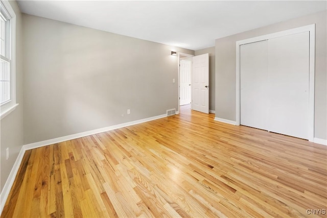 14 Ibis, Clay, NY 13090 - unfurnished bedroom featuring light wood-style floors and a closet