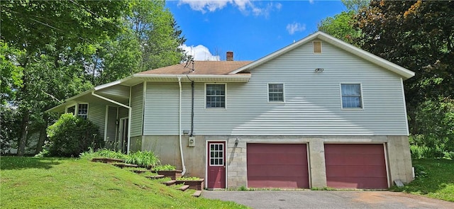 52856 State Highway 30, Roxbury, NY 12477 - back of property featuring an attached garage, asphalt driveway, a lawn, and a chimney