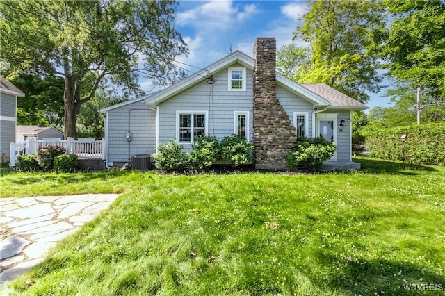 52 Harbor St, Wilson, NY 14172 - rear view of property featuring a chimney and a lawn