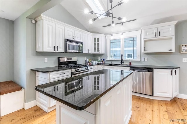 52 Harbor St, Wilson, NY 14172 - kitchen featuring stainless steel appliances, white cabinets, light wood-type flooring, a chandelier, and a kitchen island