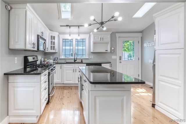 52 Harbor St, Wilson, NY 14172 - kitchen with stainless steel appliances, a skylight, and light wood finished floors