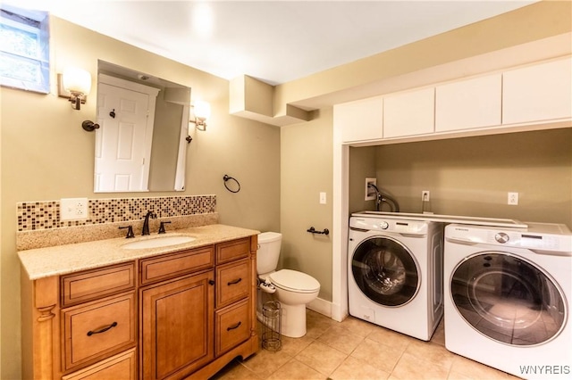 52 Harbor St, Wilson, NY 14172 - bathroom featuring washer and clothes dryer, vanity, tile patterned flooring, and tasteful backsplash