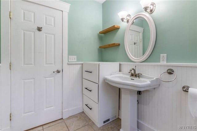 52 Harbor St, Wilson, NY 14172 - bathroom featuring wainscoting and tile patterned floors