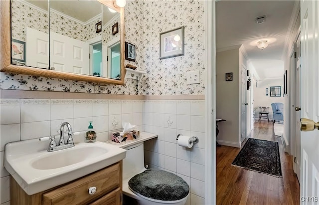 16 Vine Cir, Whitestown, NY 13492 - bathroom with ornamental molding, wood finished floors, wallpapered walls, vanity, and tile walls