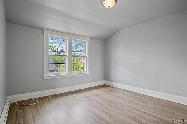1810 Niagara St, Niagara Falls, NY 14303 - empty room featuring lofted ceiling, wood finished floors, and a baseboard radiator