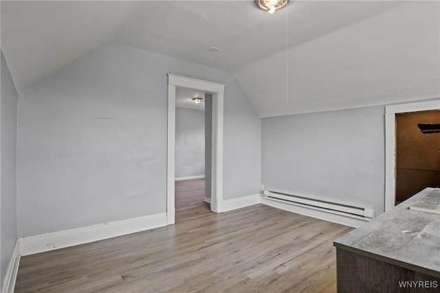 1810 Niagara St, Niagara Falls, NY 14303 - bonus room with a baseboard radiator, vaulted ceiling, and wood finished floors