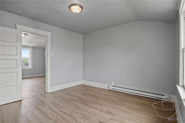 1810 Niagara St, Niagara Falls, NY 14303 - spare room featuring a baseboard radiator, wood finished floors, and lofted ceiling