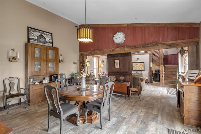 2244 Lockport Olcott Rd, Newfane, NY 14108 - dining area with a high ceiling, wooden walls, light wood finished floors, a fireplace, and crown molding