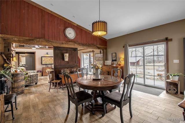 2244 Lockport Olcott Rd, Newfane, NY 14108 - dining space featuring light wood-type flooring, high vaulted ceiling, and wood walls