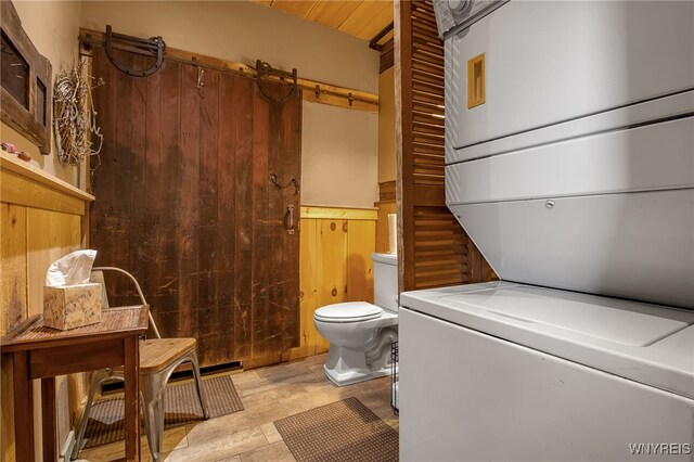 2244 Lockport Olcott Rd, Newfane, NY 14108 - bathroom with estacked washer and dryer and wooden walls