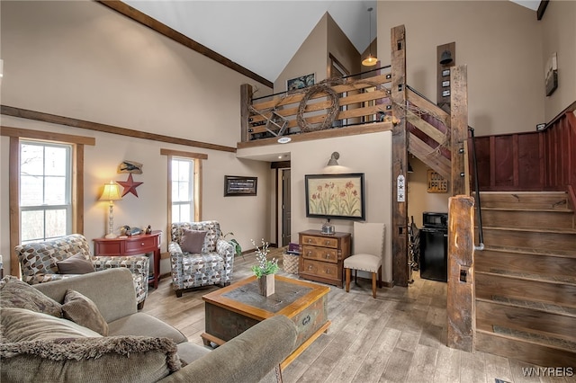 2244 Lockport Olcott Rd, Newfane, NY 14108 - living area with high vaulted ceiling, stairs, and light wood finished floors