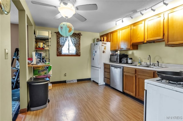 6192 Thornwood Dr, Boston, NY 14075 - kitchen with white appliances, a ceiling fan, light countertops, light wood-style flooring, and brown cabinetry