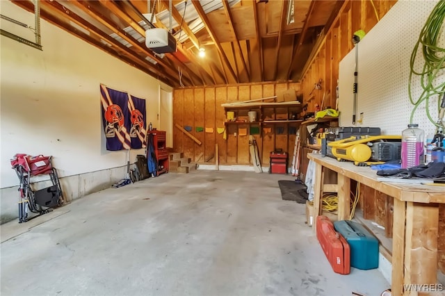6192 Thornwood Dr, Boston, NY 14075 - garage with a garage door opener and a workshop area